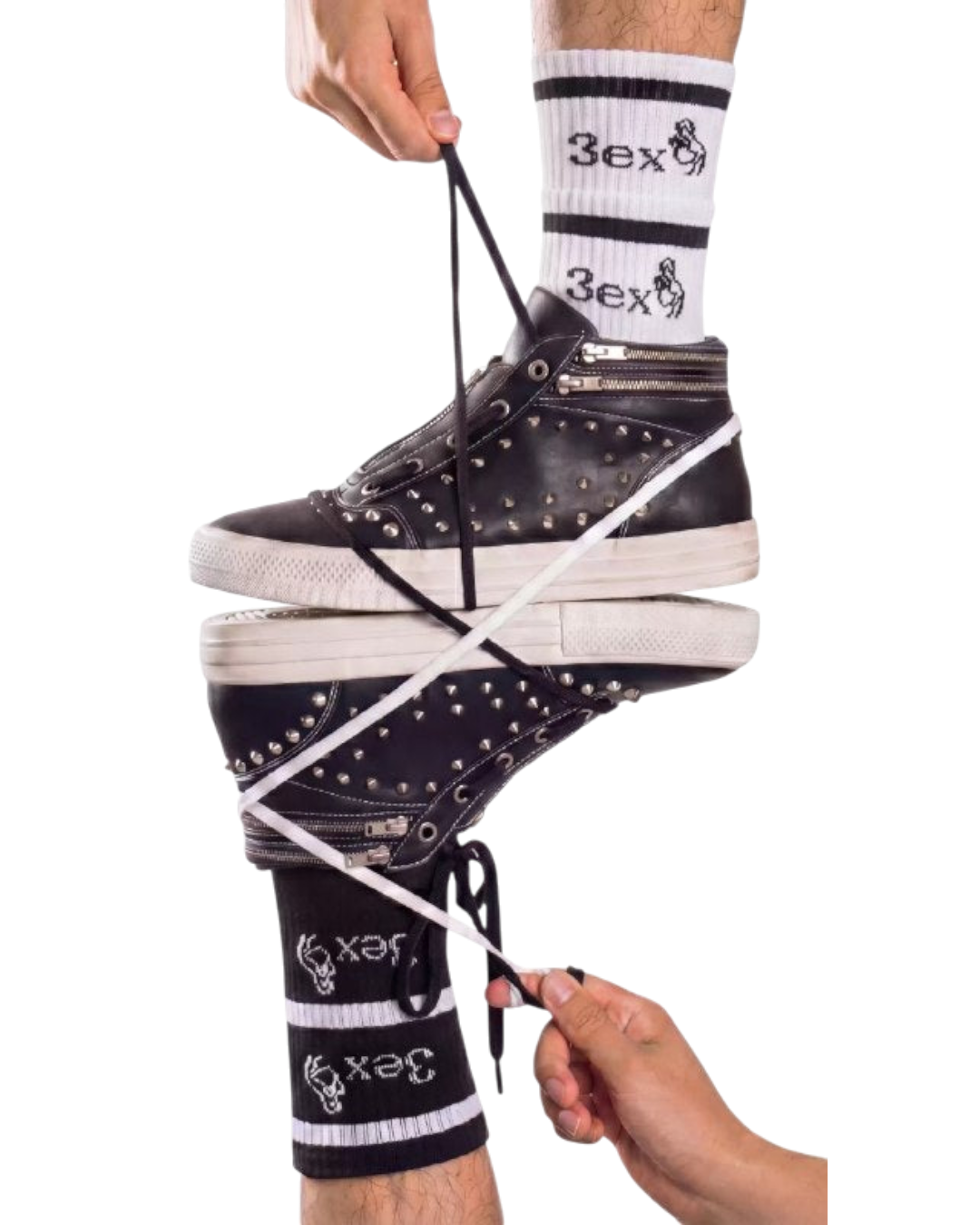 Black studded zip skate sneaker on foot, white sole and silver zipper pull