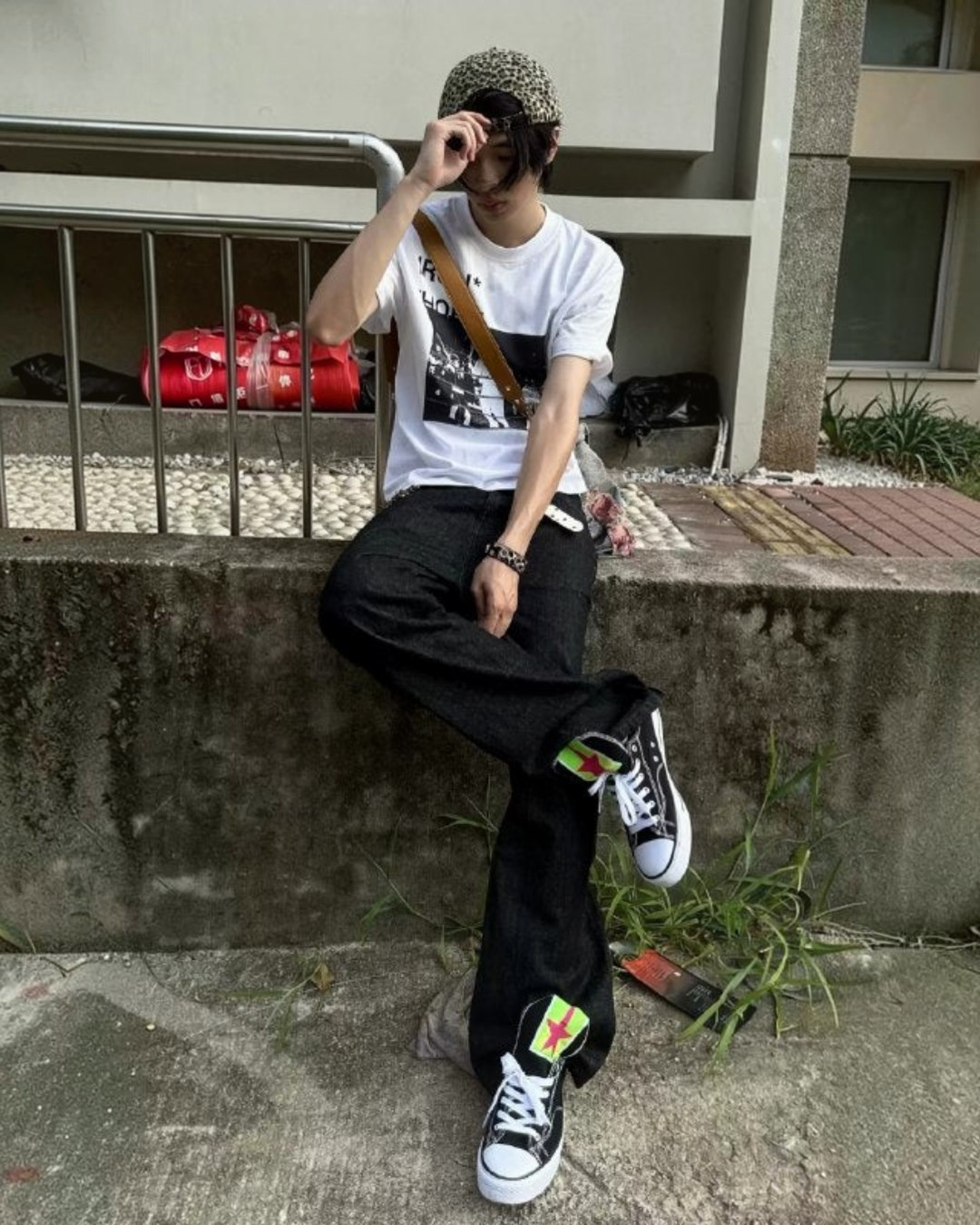 Black canvas sneakers with neon green star side patches and white rubber soles