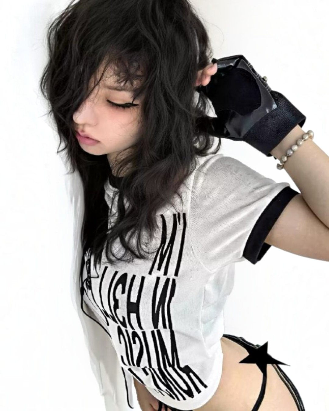 White graphic T-shirt with black text print and woman silhouette, angled close-up
