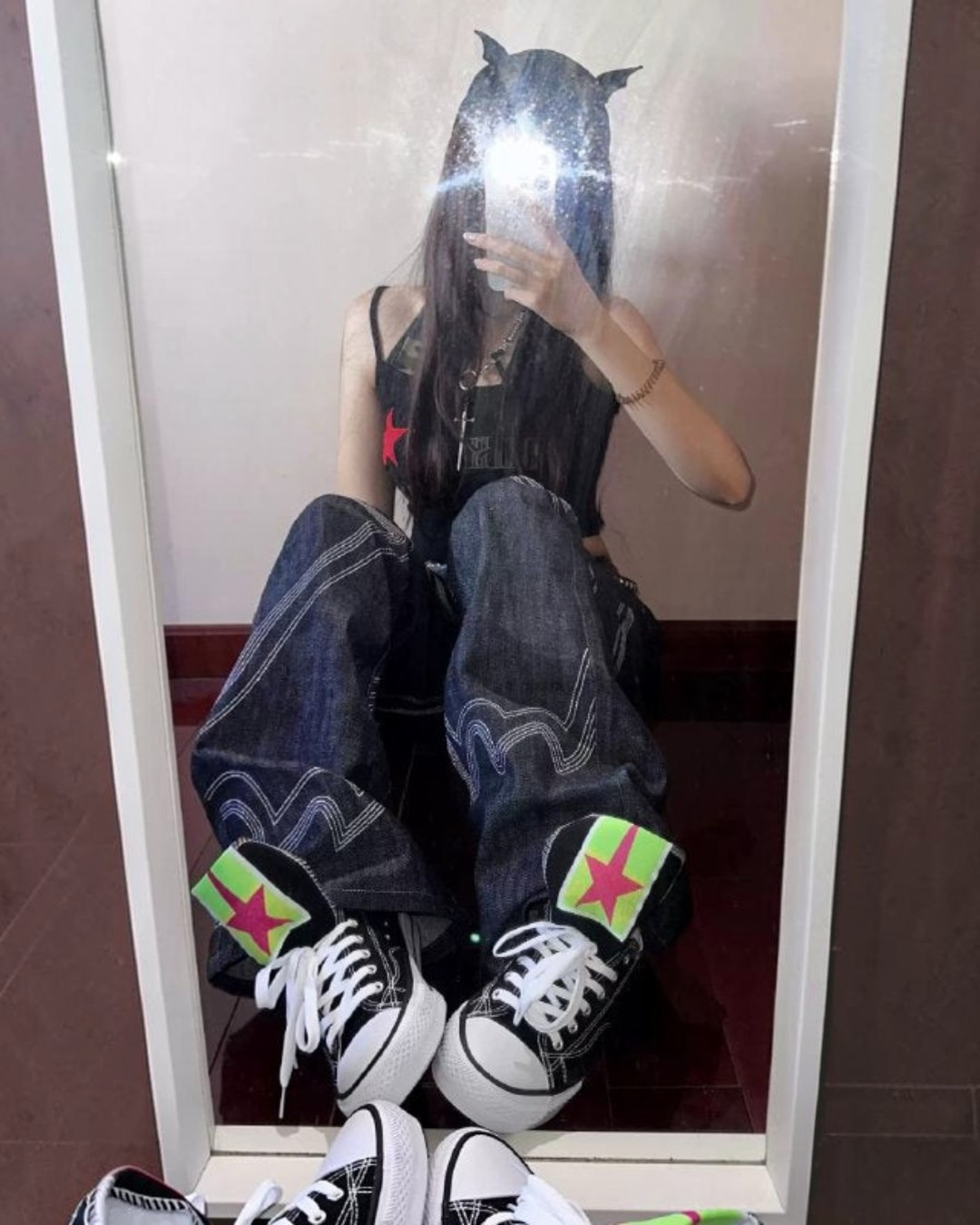 Black canvas sneakers with neon green star patches and white laces