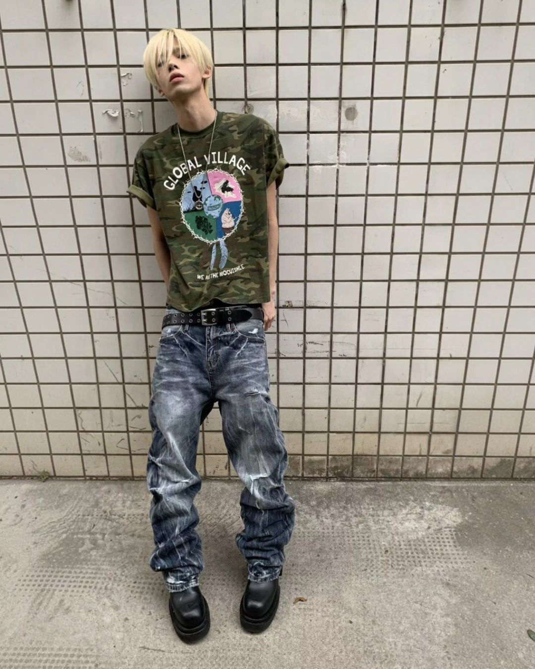 Blue distressed baggy jeans on model, relaxed fit with multiple rips and faded wash