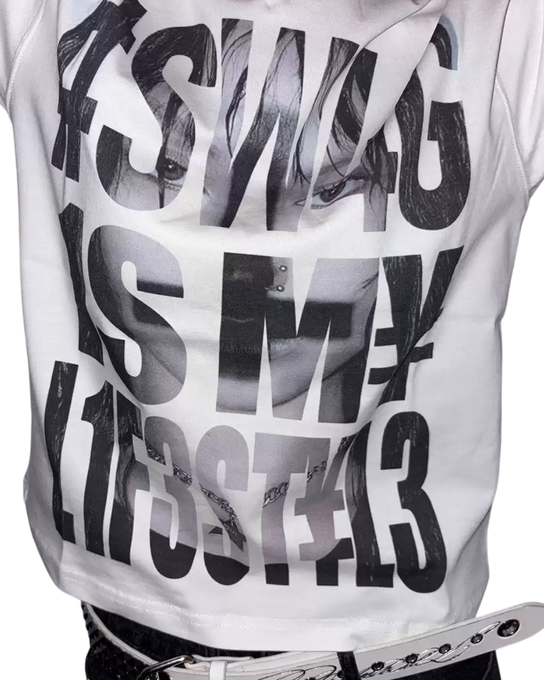 White T-shirt close-up showing large black hashtag typography print