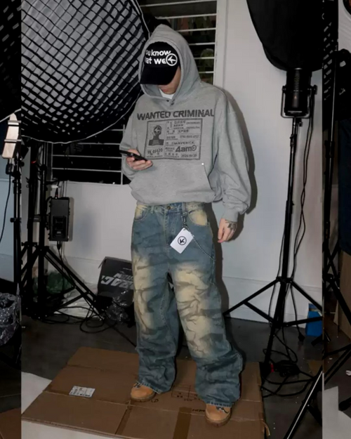 Faded blue baggy jeans with distressed wash panels and relaxed fit wide legs