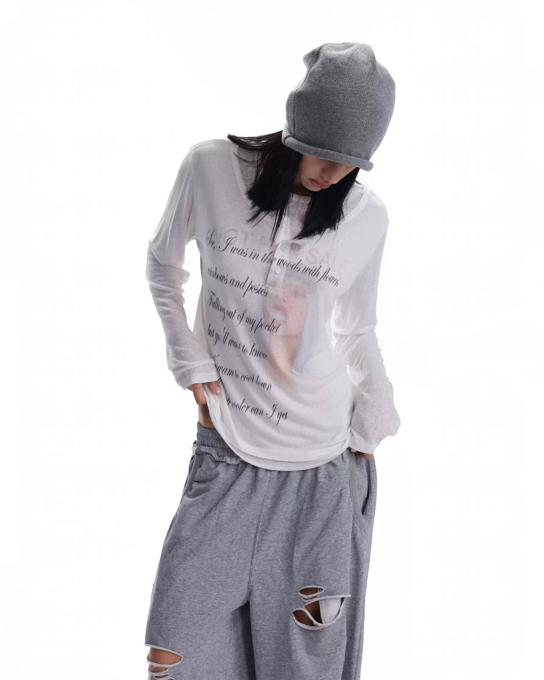 White poet layer top, long sleeves, crew neck, center script graphic.