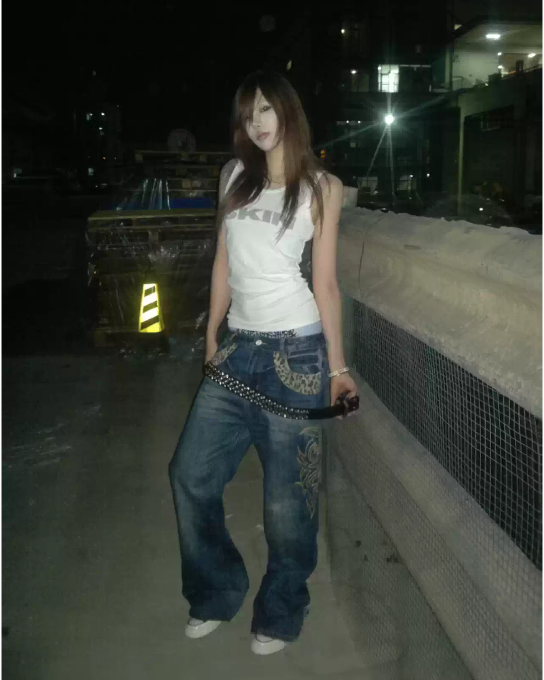 Dark blue flare denim jeans with ornate tribal patches along outer legs