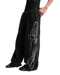 Black embroidered baggy sweatpants close-up of side line graphic and pleated waistband