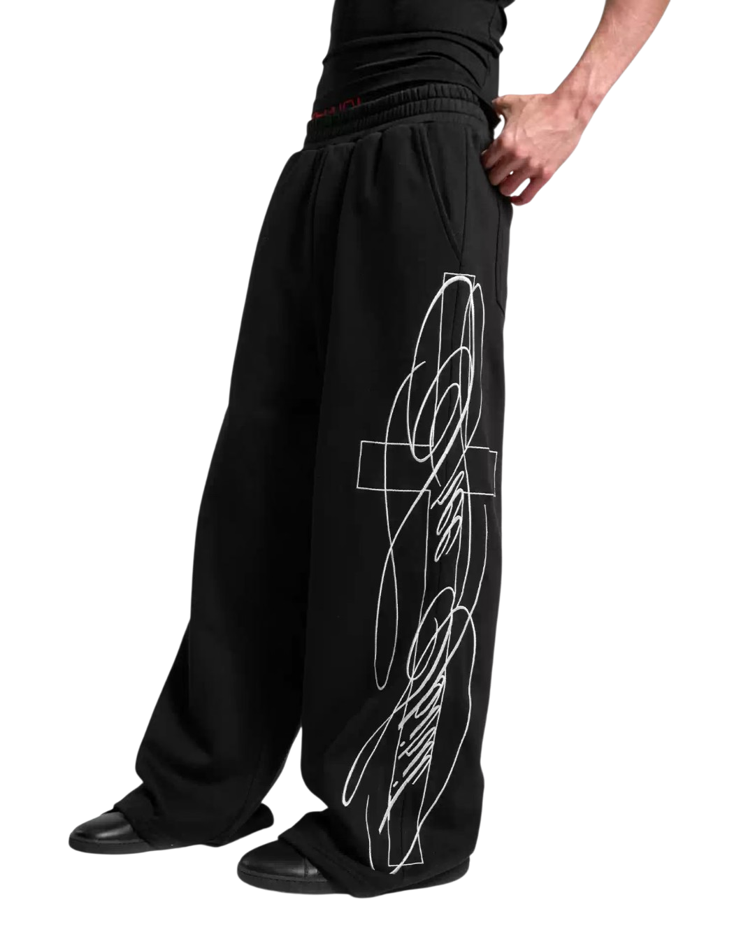 Black embroidered baggy sweatpants close-up of side line graphic and pleated waistband