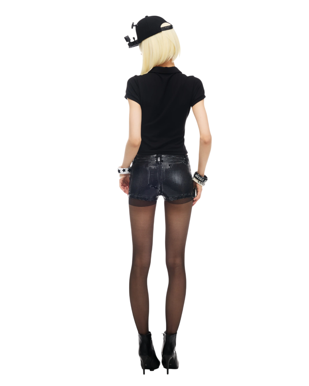 Person wearing a black outfit with a cap on a white background