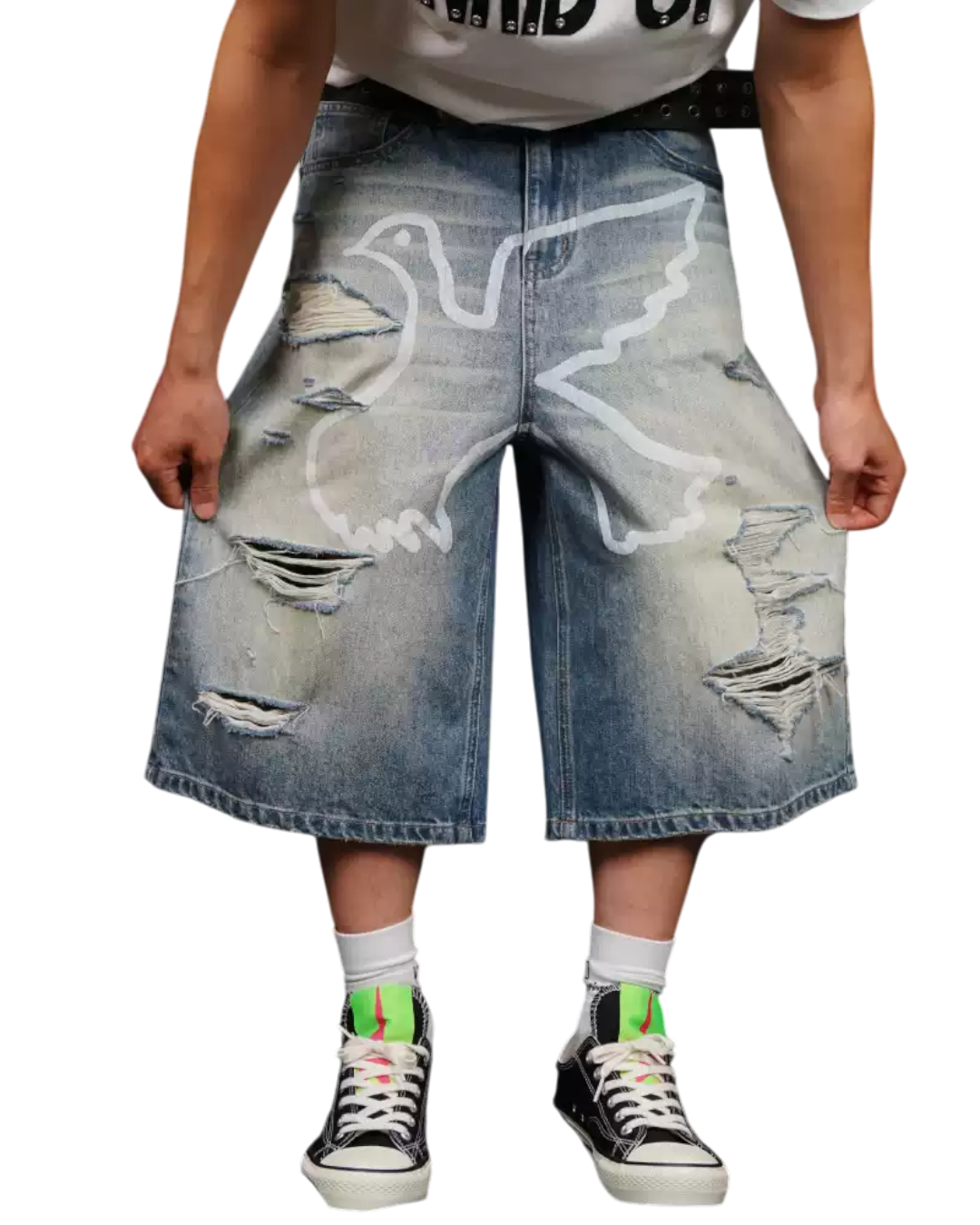 Person wearing distressed denim shorts on a white background