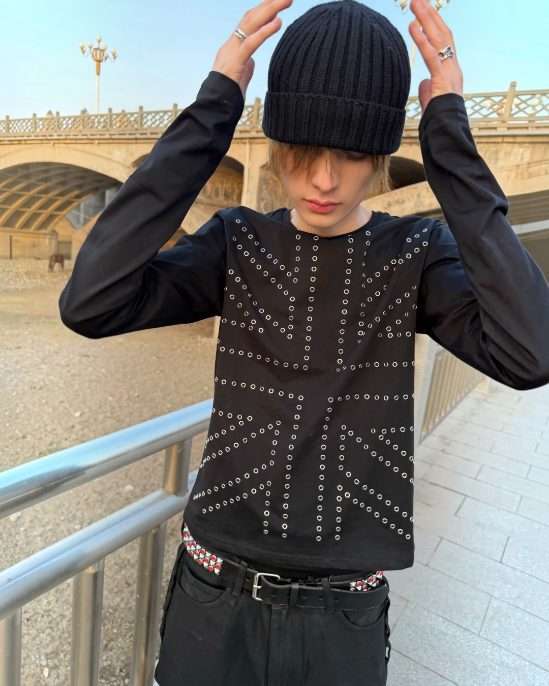 Black studded long-sleeve top with symmetrical dot-studded graphic front