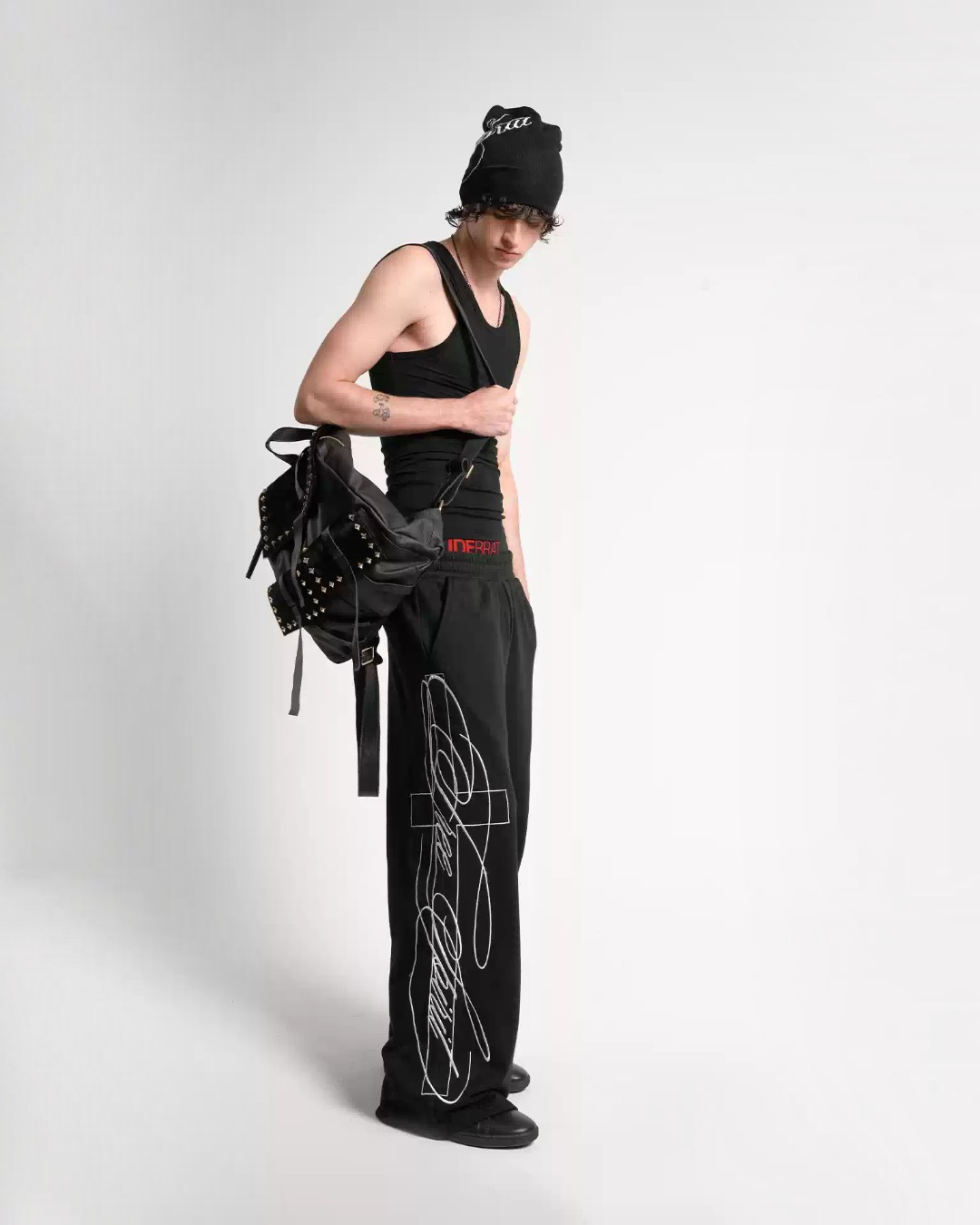 Black embroidered baggy sweatpants, wide legs and bold line graphics on side