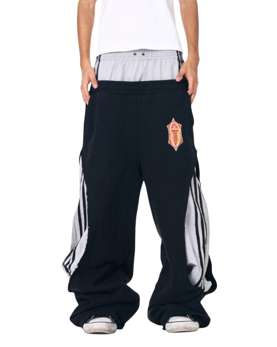 Dark track pants with red crest patch, elastic waistband, side stripe panels, wide legs