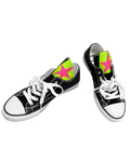 Black canvas sneakers with neon green star panels, white laces, and white rubber toe caps