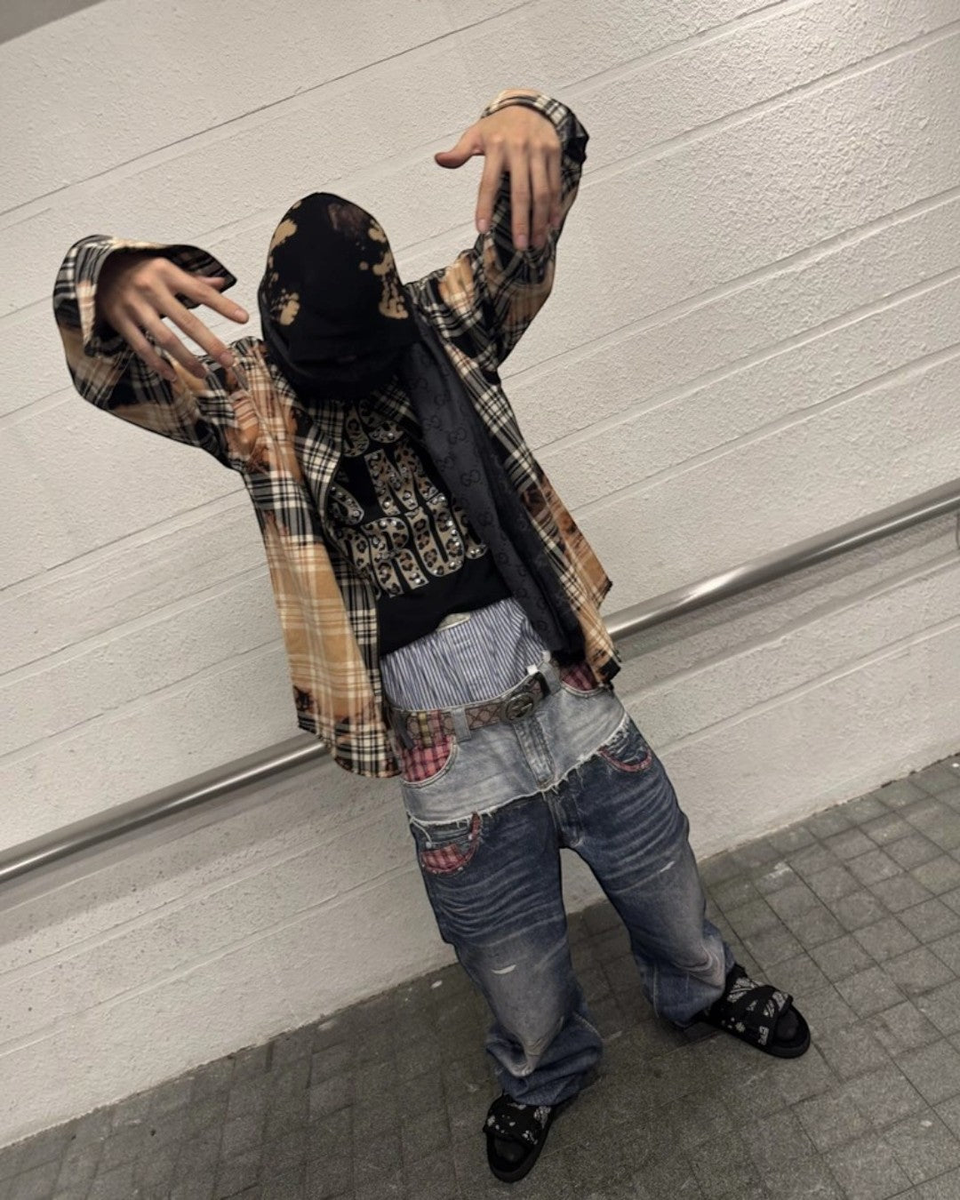 Distressed light-blue denim jeans with wide legs, patched rips, and faded whiskering