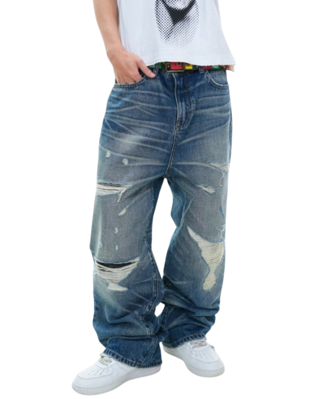 Person wearing distressed blue jeans on a white background