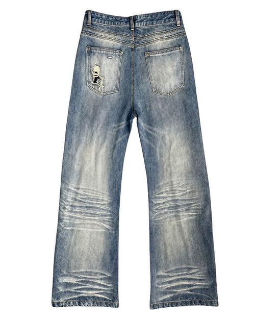 Light blue denim jeans with a heavily distressed and faded wash, featuring a ripped detail on the back right pocket, shown against a plain white background.